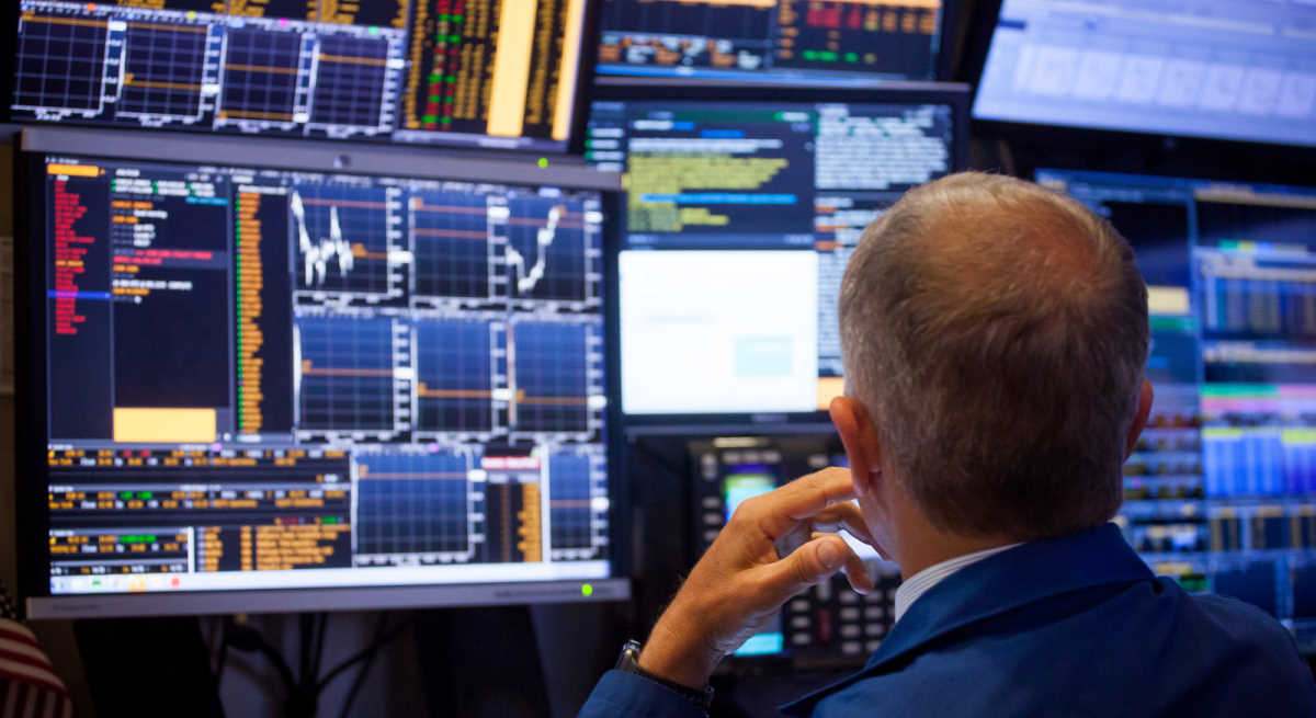 Un señor mirando su terminal de Bloomberg