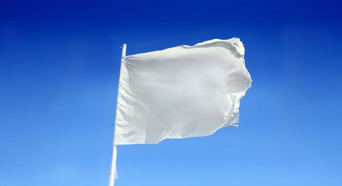Bandera blanca ondeando en el viento