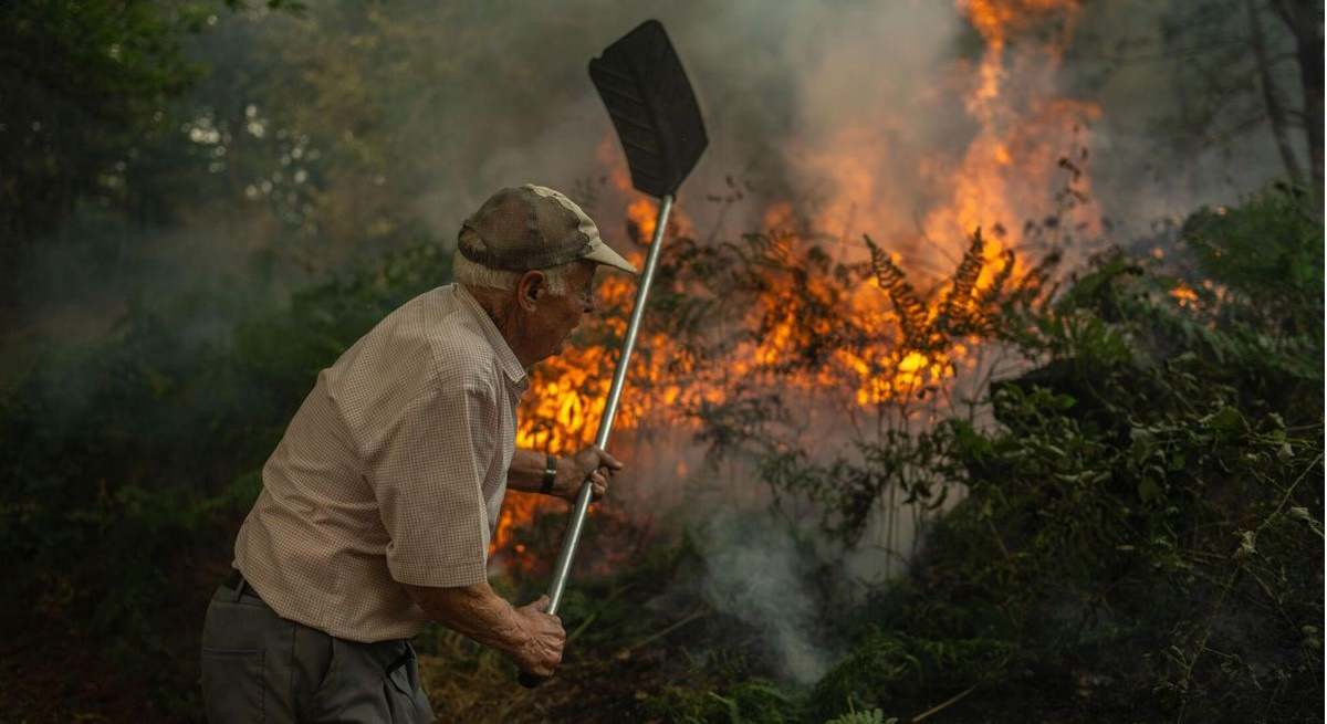 Vecino intentando sofocar un incendio cerca de su casa.