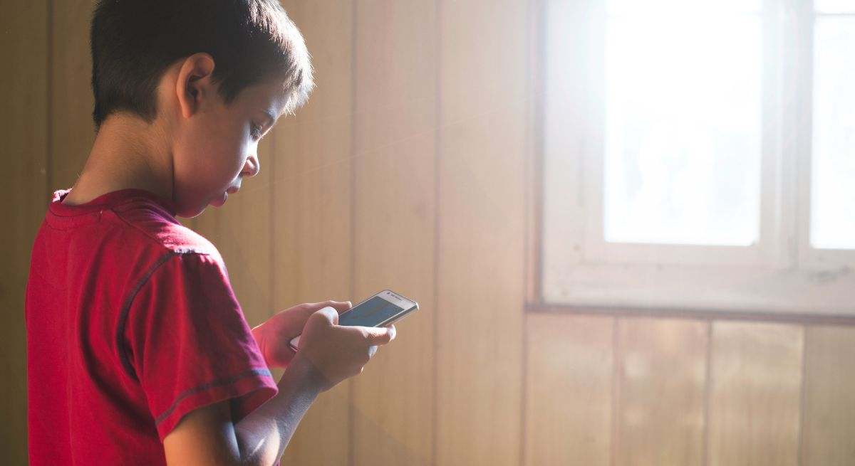 Un niño pegado al teléfono móvil