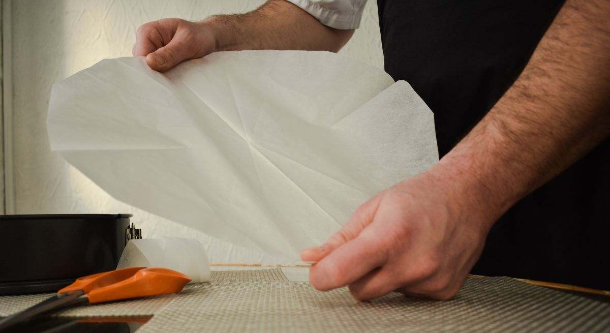 Señor colocando el papel de horno