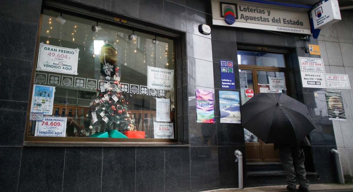 Un hombre entra a una administración de Lotería.