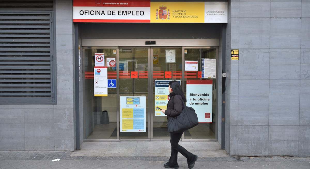 Mujer pasa delante de una oficina de empleo
