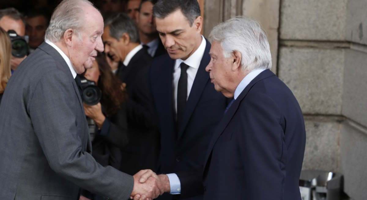 Juan Carlos I estrecha la mano de Felipe González en presencia de Pedro Sánchez