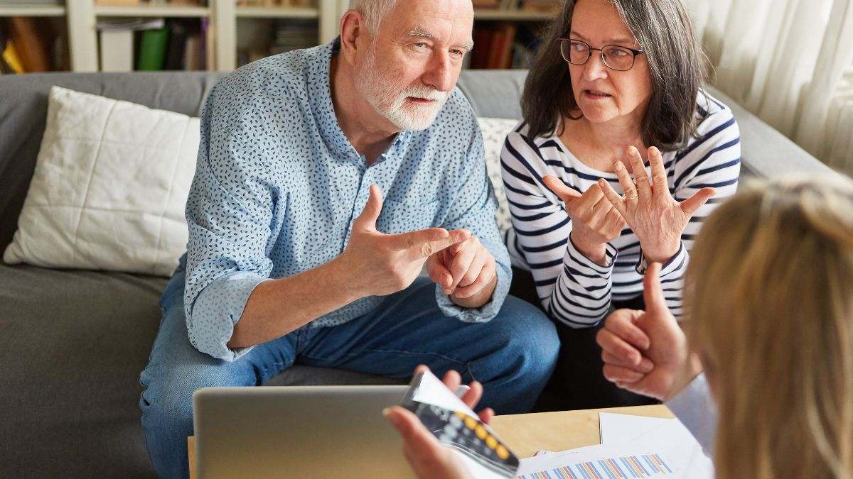 Dos jubilados hacen cuentas en su casa.