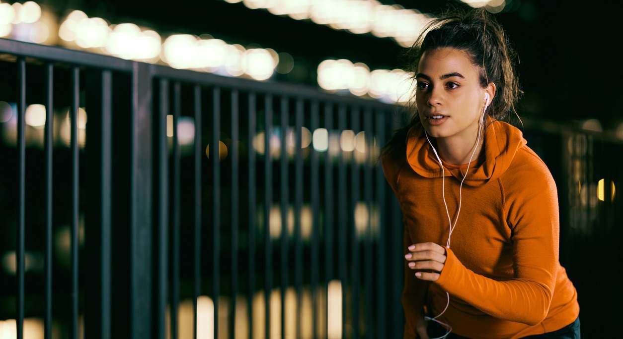 una mujer practica deporte en horario nocturno