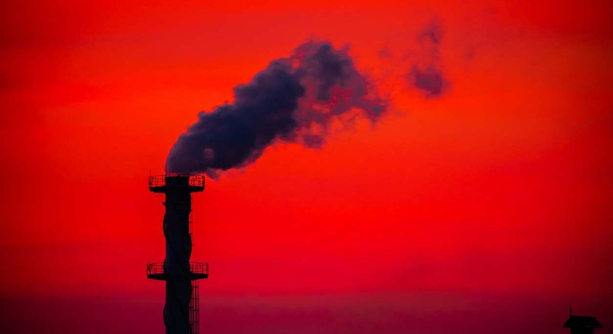 Chimenea de fábrica ante cielo rojo