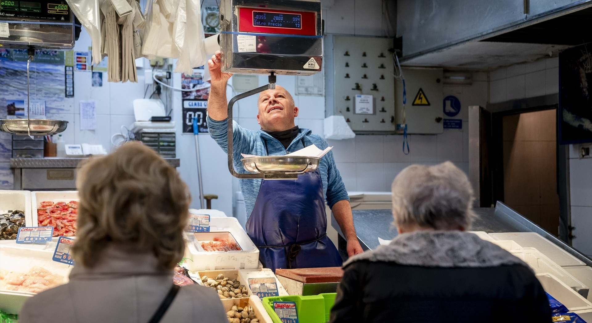 Varias personas hacen compras de última hora en un mercado | EP
