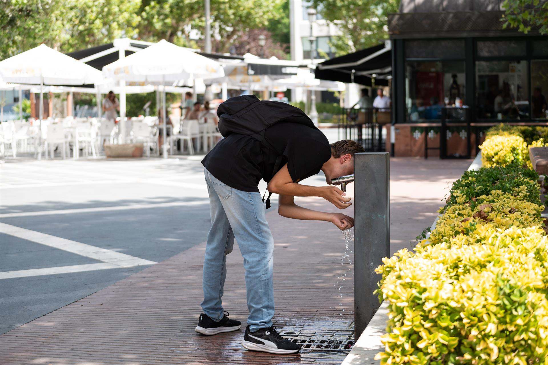 Hombre bebiendo en una fuente
