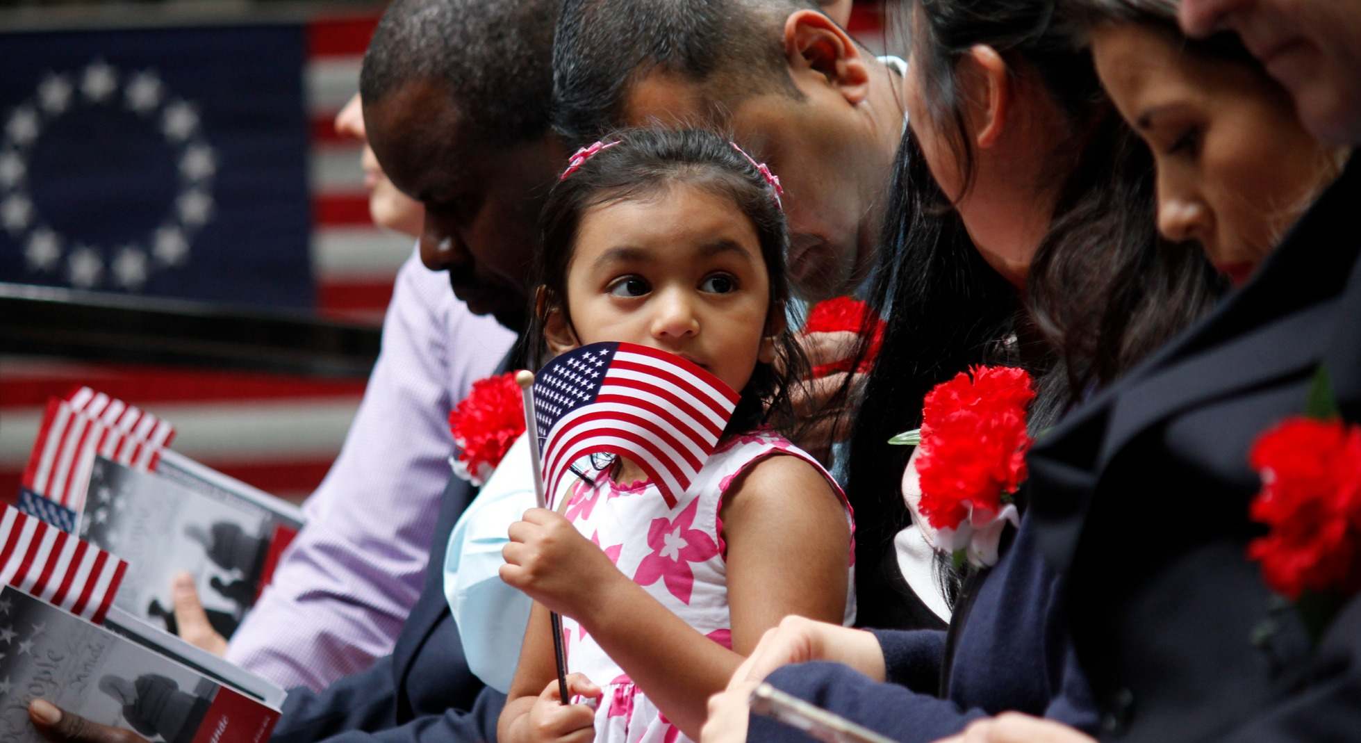 Una niña sostiene una bandera estadounidense