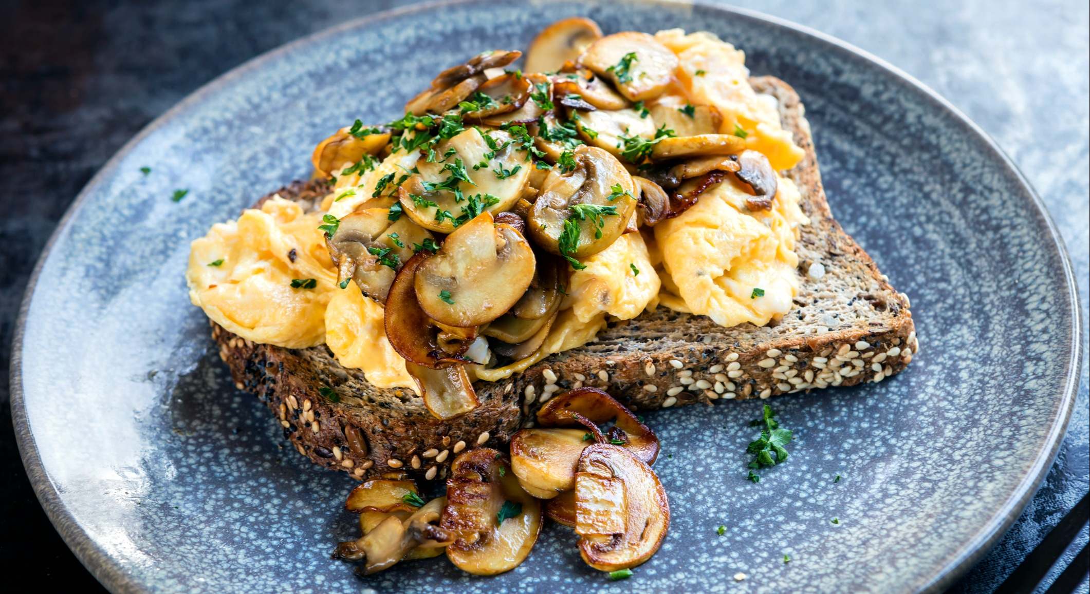 Huevos revueltos y champiñones en pan tostado