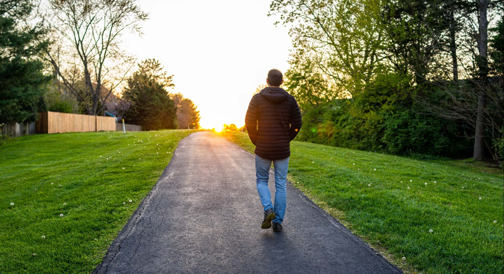 Silueta del hombre caminando hacia la puesta de sol