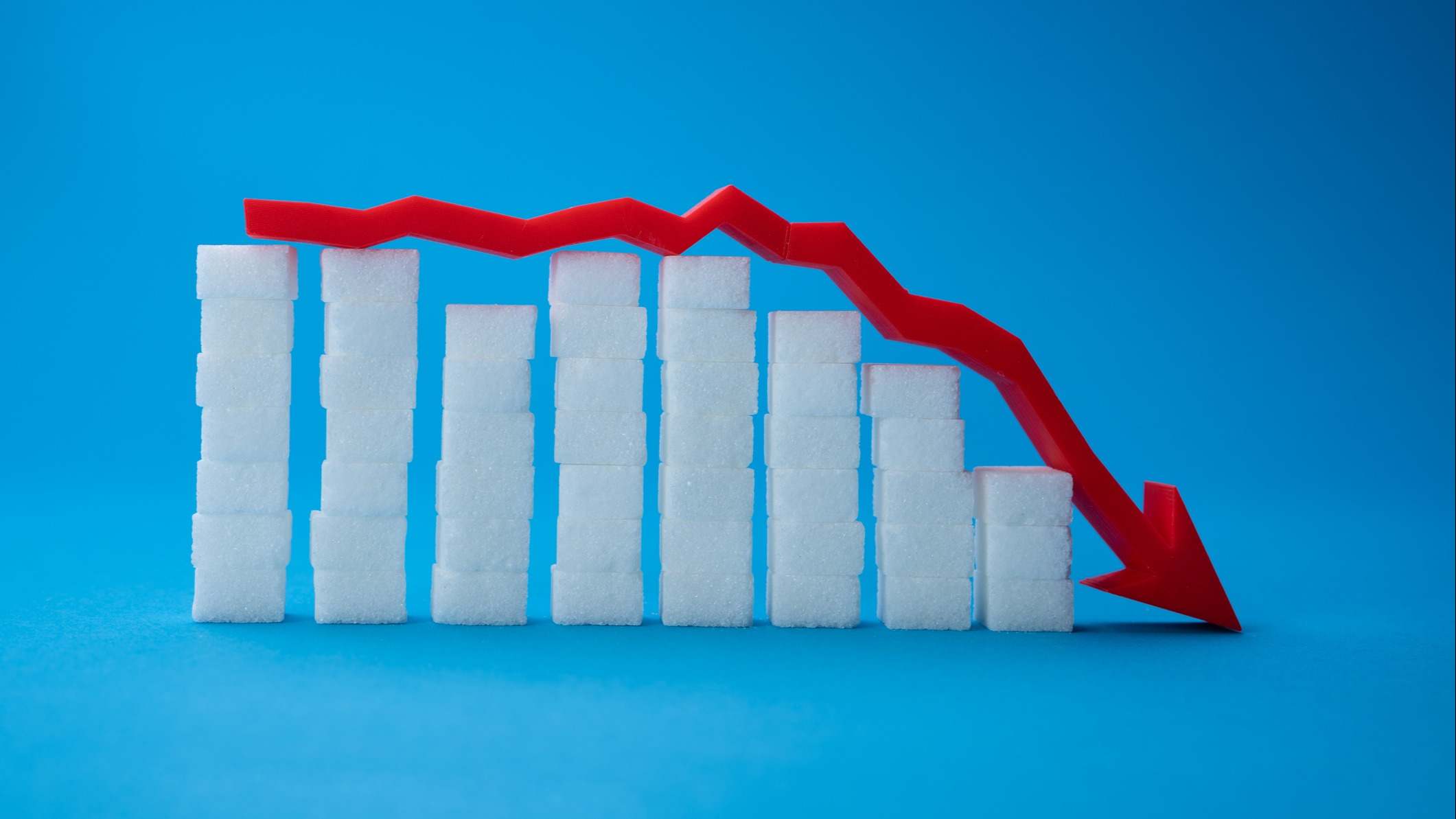 Gráfico elaborado con torres de terrones de azúcar y una flecha roja que simboliza la sangre