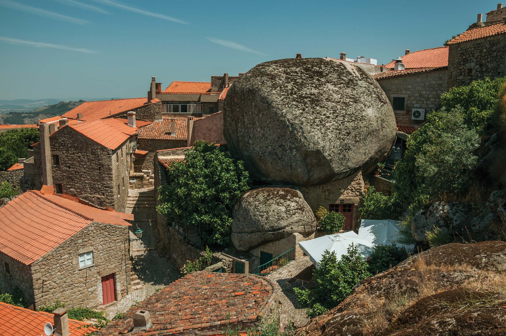 Tejados de antiguas casas de piedra con rocas redondeadas en Monsanto