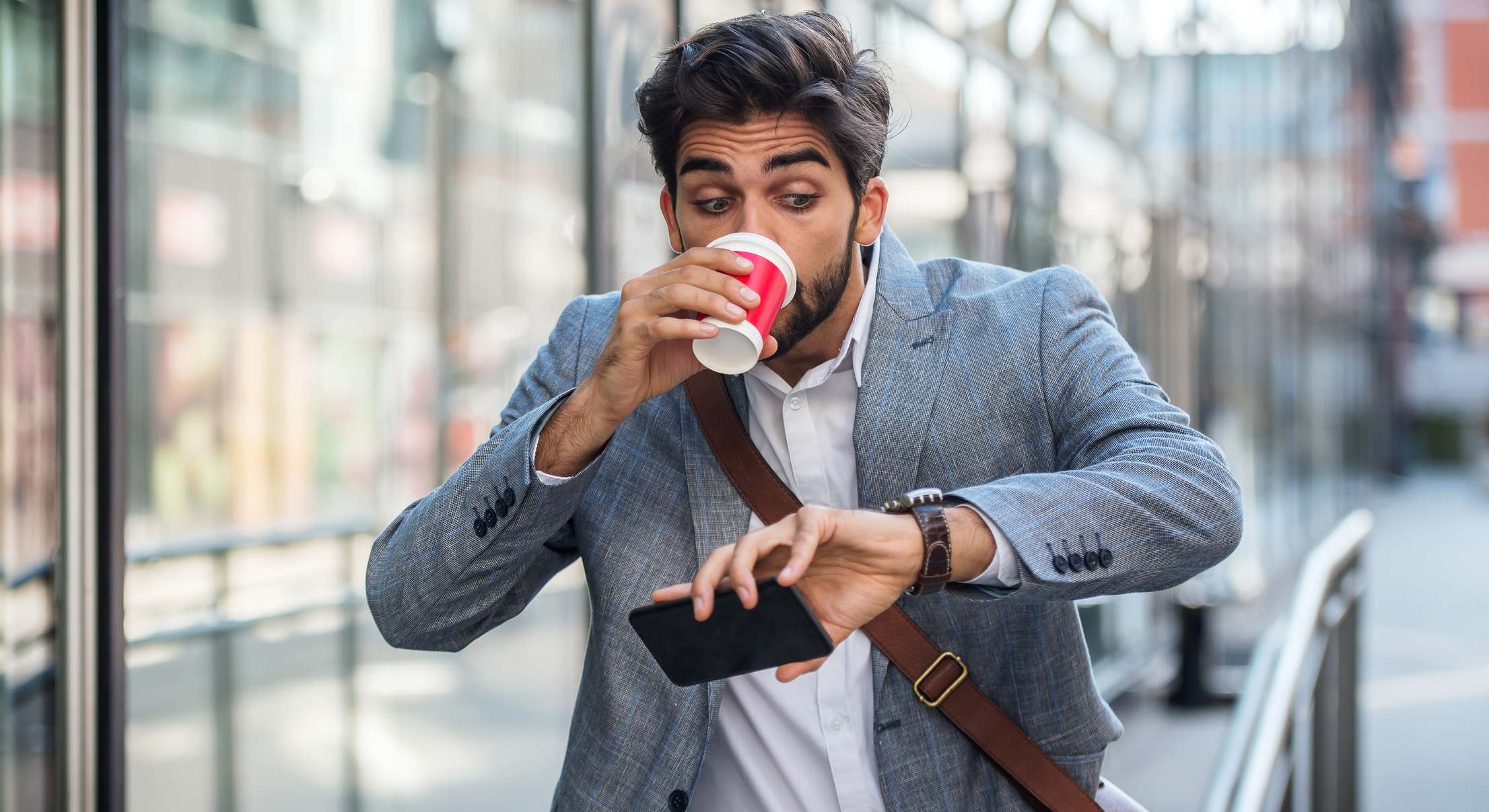 Hombre preocupado mirando su reloj de camino al trabajo