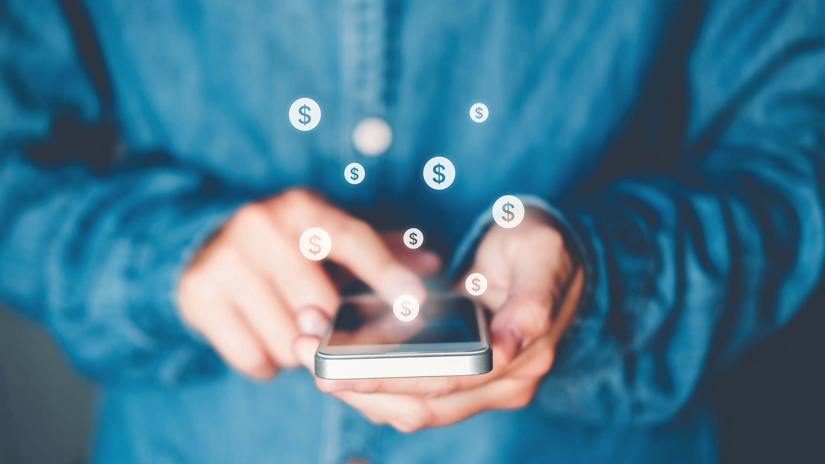 Símbolos del dólar salen de un teléfono móvil