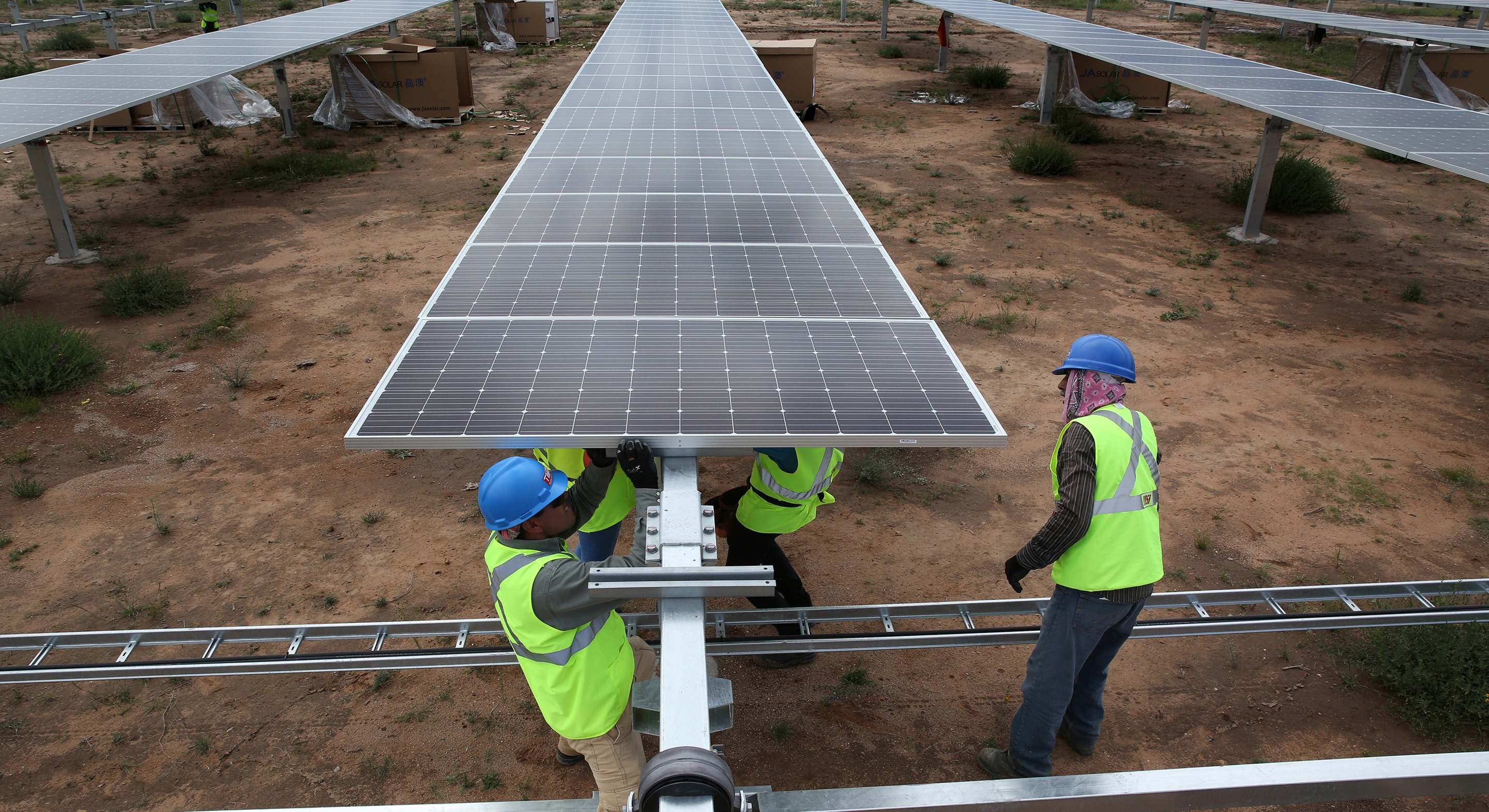 Unos operarios instalan unos paneles solares. eE