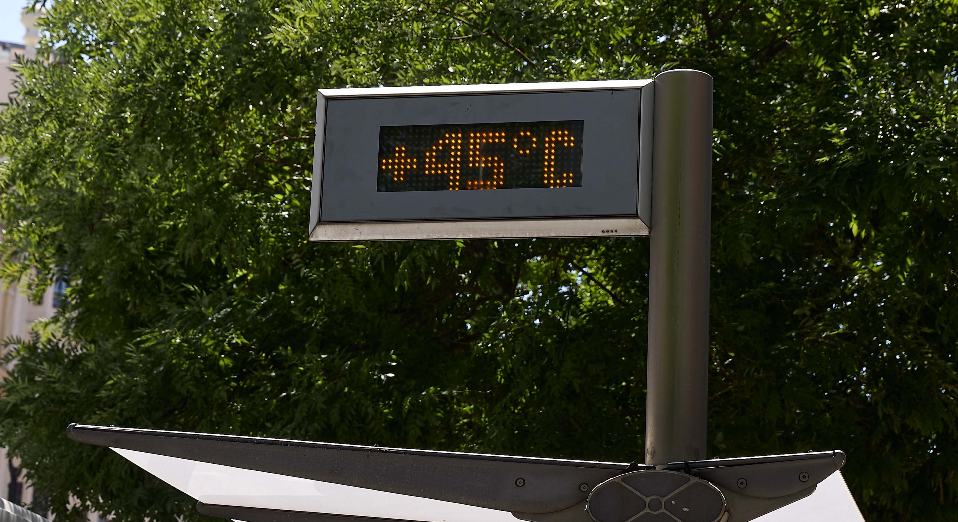 Imagen de recurso de una marquesina de autobús con un termómetro a 45 grados. 