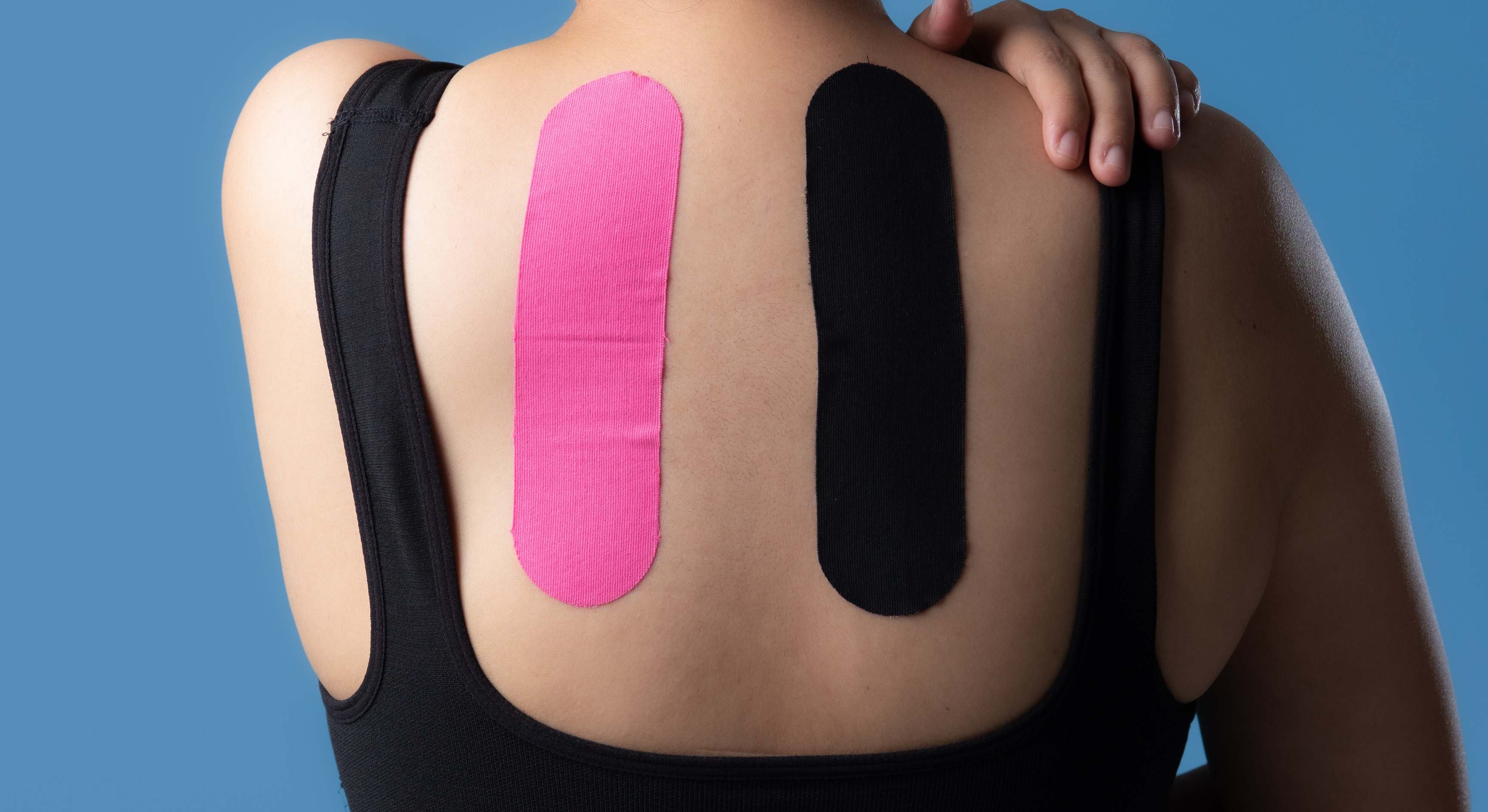 Mujer con cintas kinesiológicas en la espalda