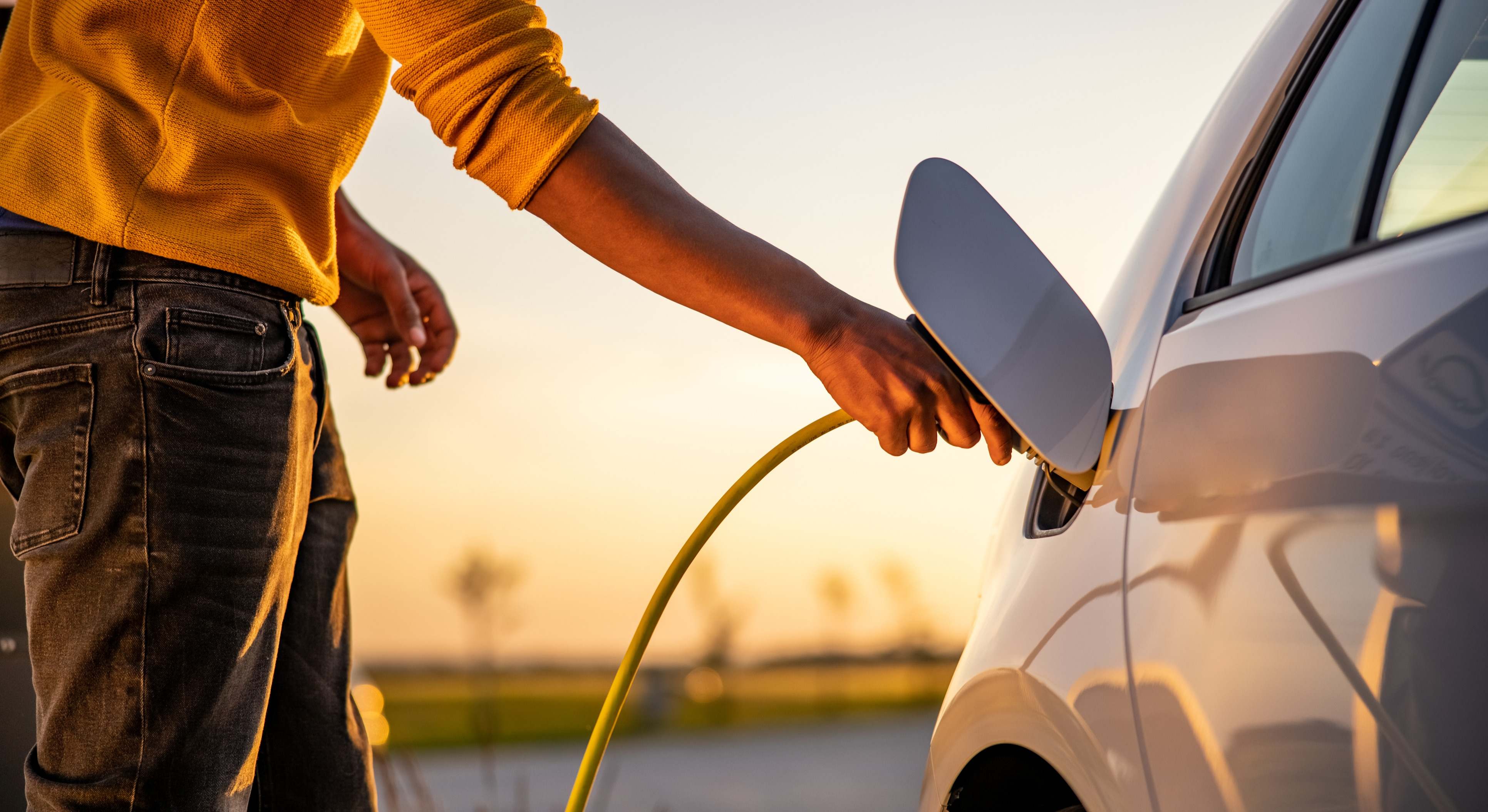 Hombre cargando un coche eléctrico