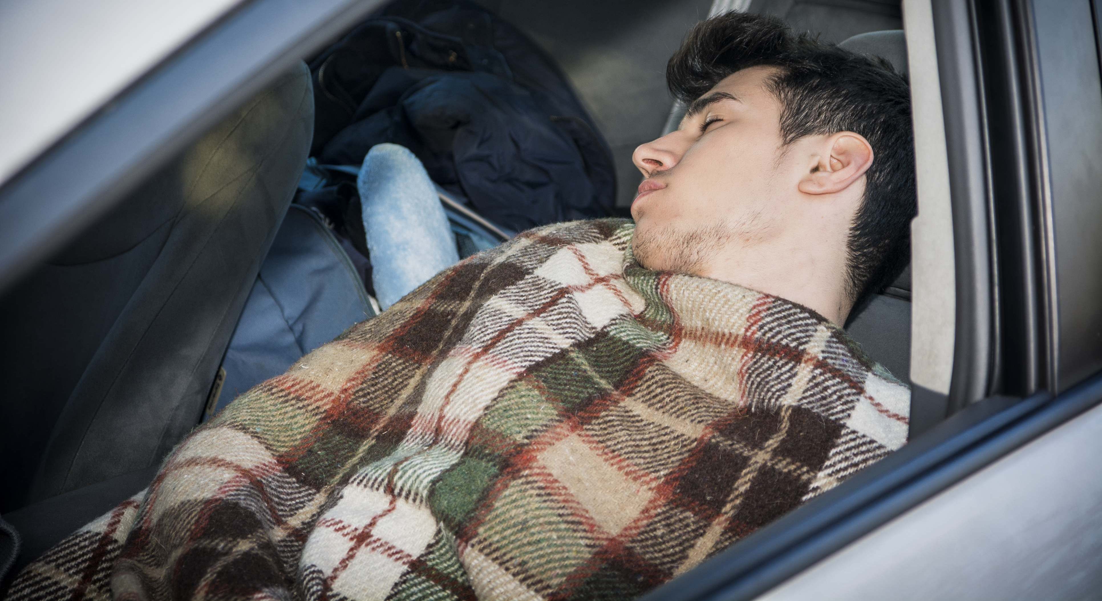 Hombre durmiendo en su coche