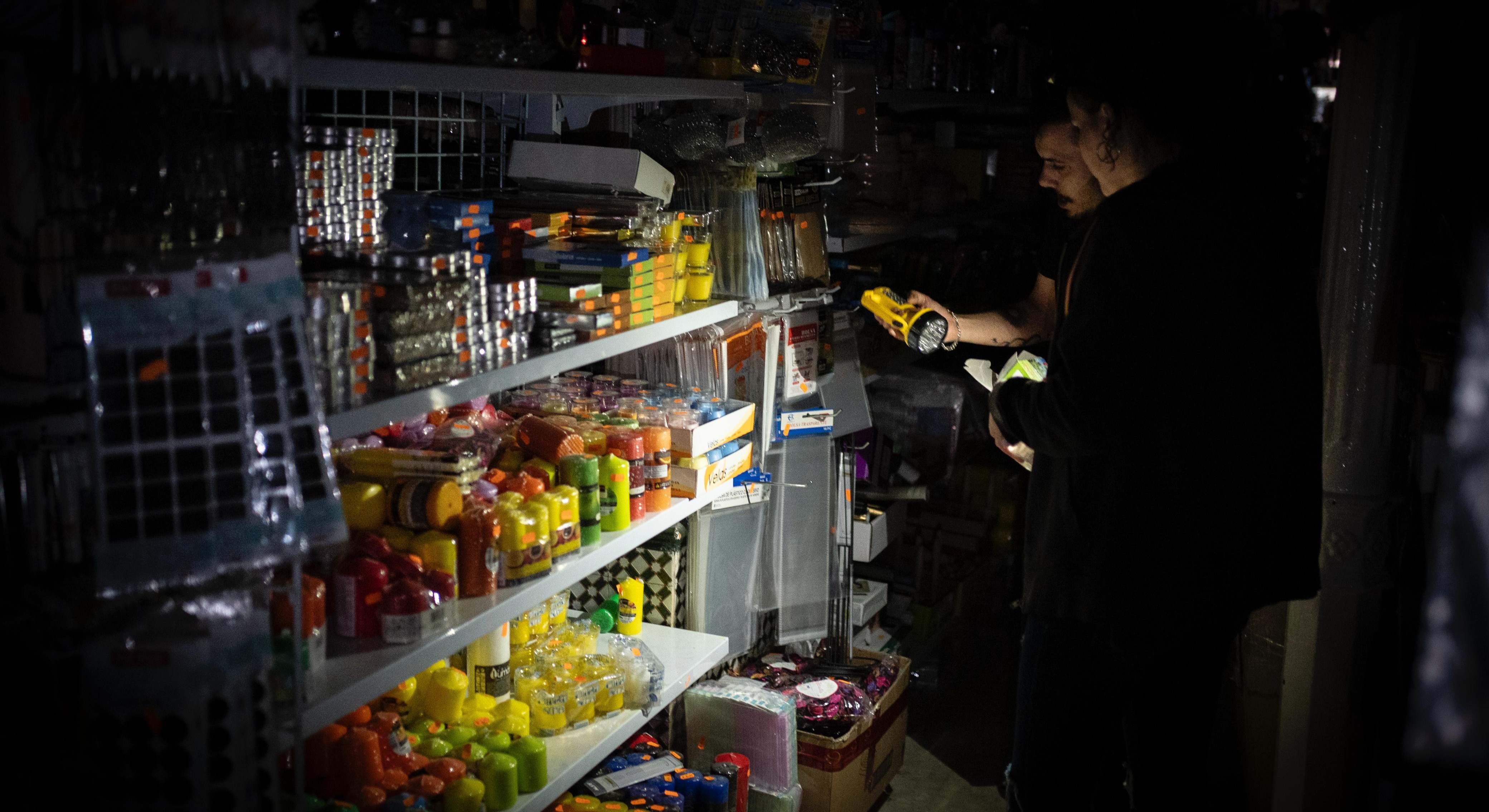 Tienda de Cádiz anoche, con clientes buscando linternas, pilas y provisiones.