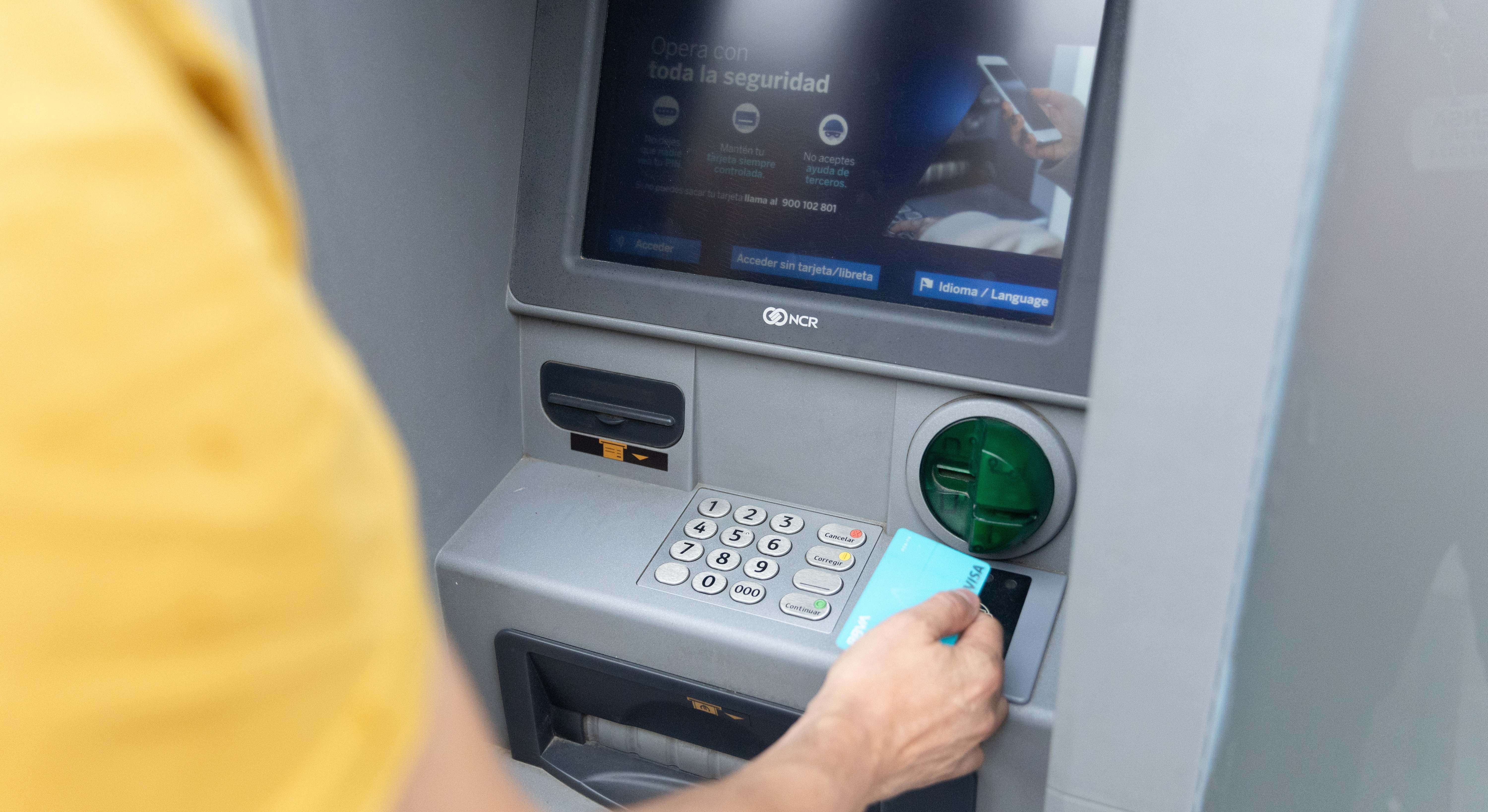 Un hombre sacando dinero del cajero