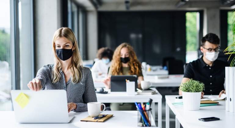 young-people-with-face-masks-back-at-work-or-school-in-office-after-picture-id1250279730.jpg