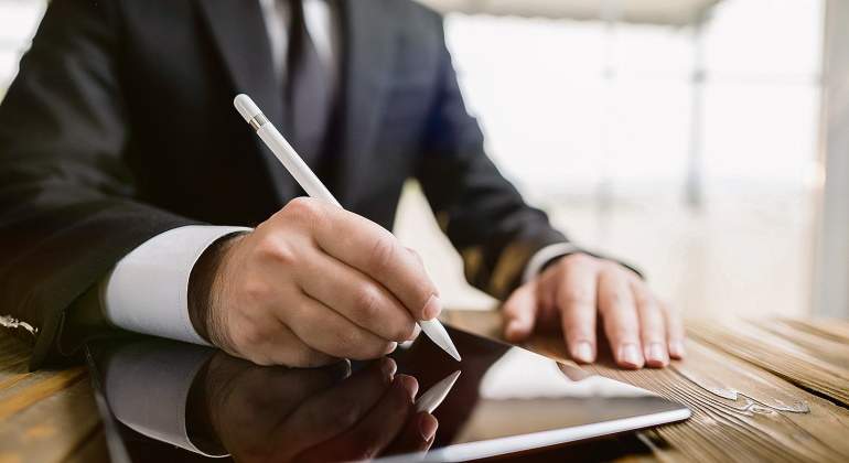 Un ejecutivo simula firmar en una tableta