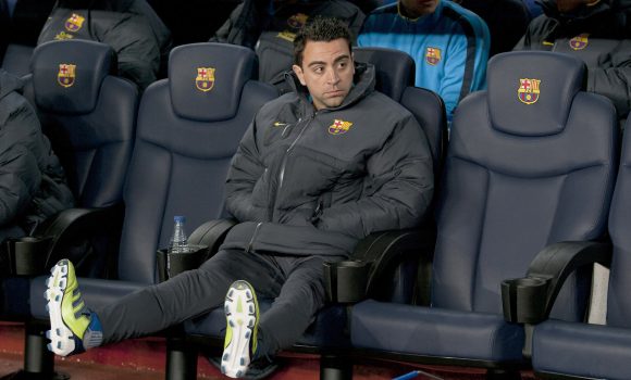 Xavi en el banquillo durante el partido frente al Valencia
