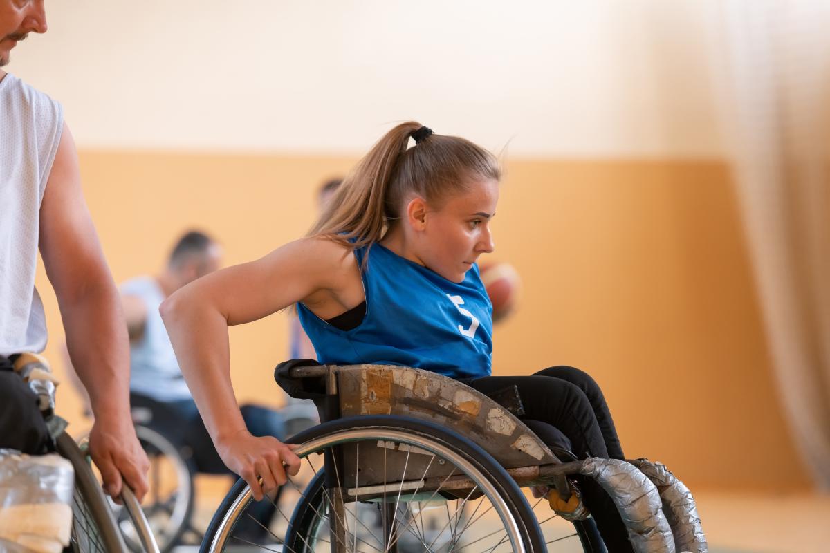 Una joven con discapacidad juega a baloncesto | Foto de 123RF/dotshock