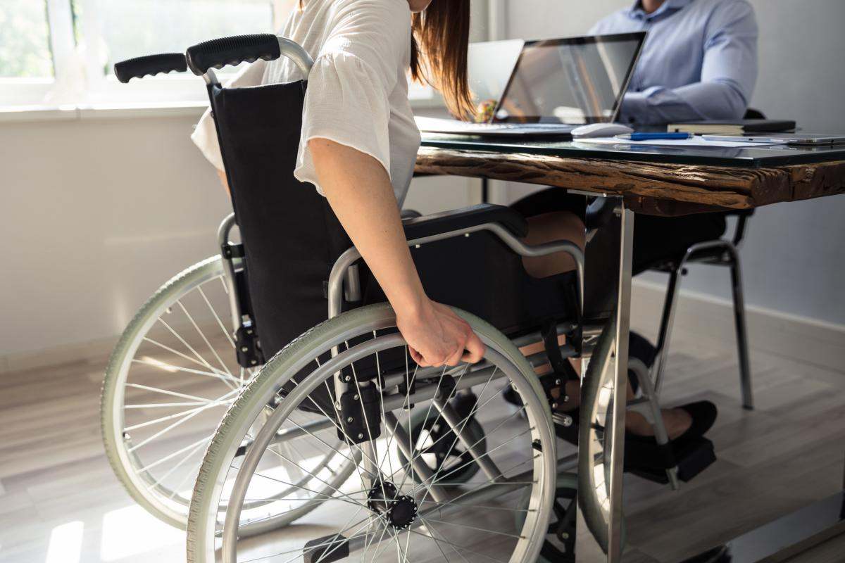 Persona con discapacidad en su puesto de trabajo | Foto de 123RF/andreypopov